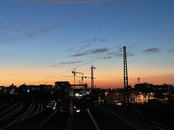 Railroad tracks against sky during sunset