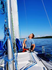 Man looking up the sails