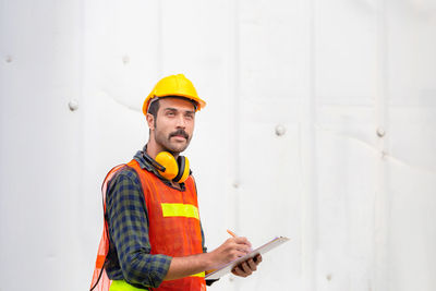 Full length of man working against wall