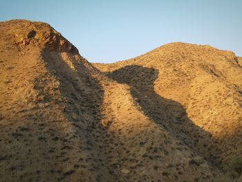 Scenic view of desert against clear sky