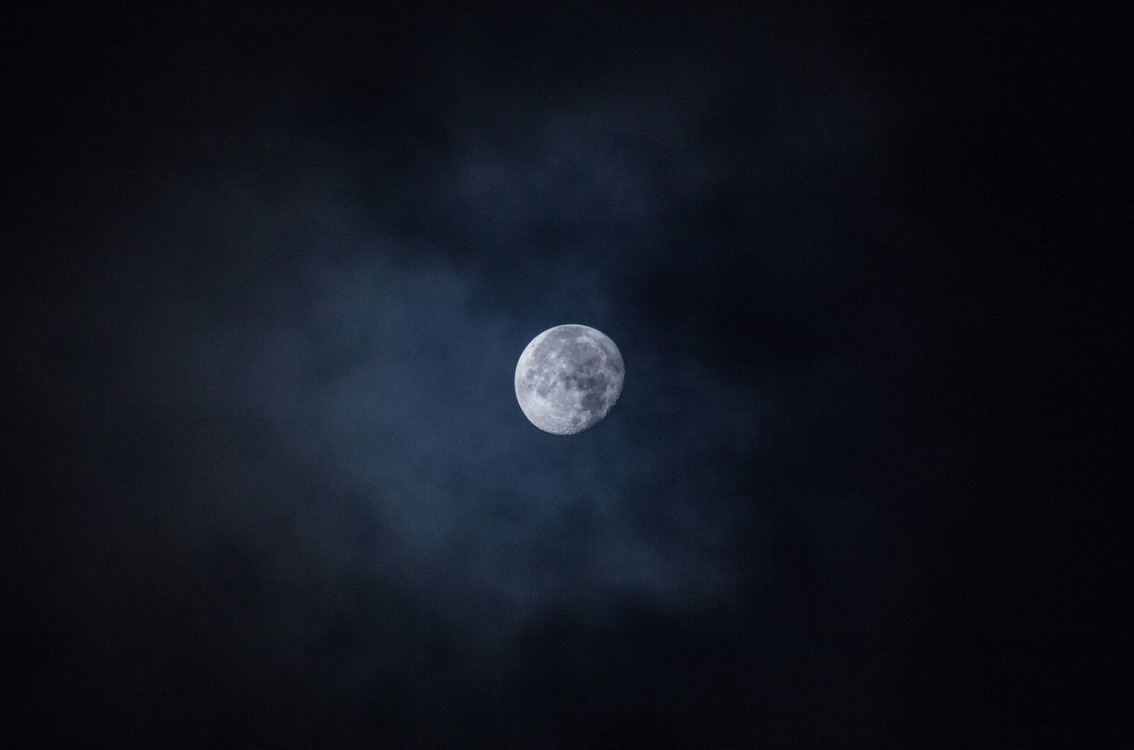 LOW ANGLE VIEW OF HALF MOON IN SKY