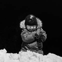 Little boy playing snowballs.