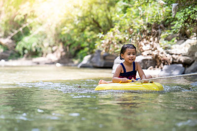 Little girl playing at mountain stream