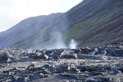 Scenic view of waterfall against sky