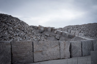 View of stone wall against cloudy sky