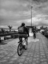 Man riding bicycle on road