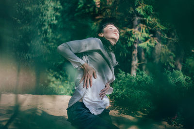 Young woman looking at camera in forest