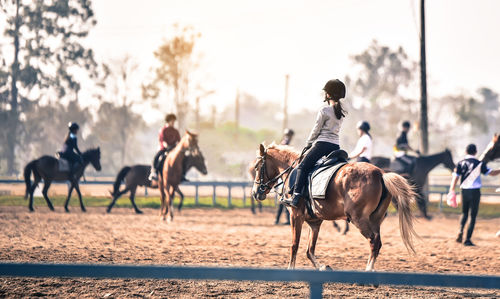 People riding horses in ranch