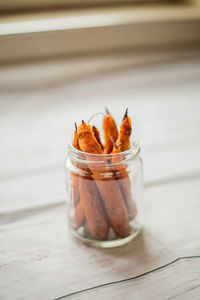 Close-up of preserves vegetable in jar on table