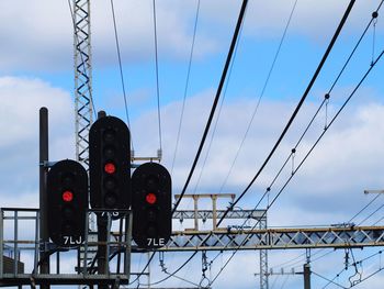 Low angle view of traffic signal against sky