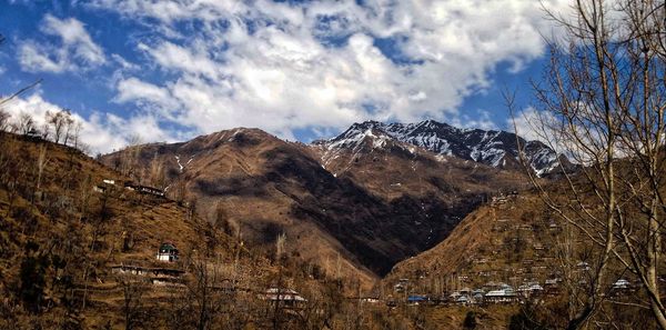 Scenic view of mountains against cloudy sky