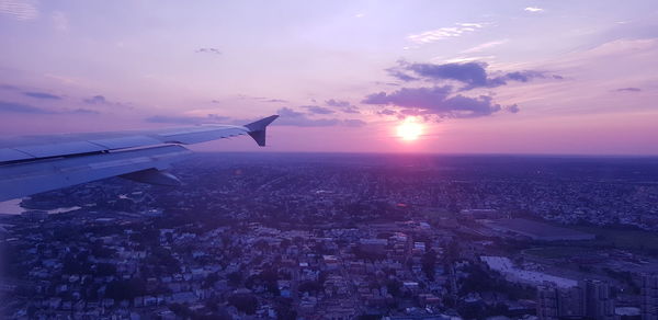 Aerial view of city against sky during sunset