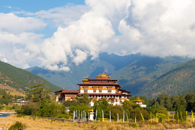 View of temple building against cloudy sky