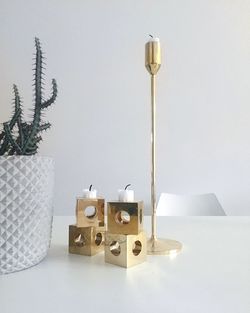 Candlestick holder on table against wall at home