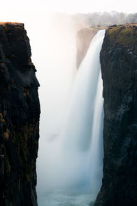 Scenic view of waterfall against rock formation