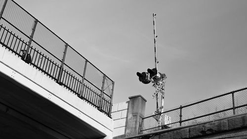 Low angle view of railroad signal against sky