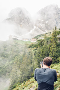 Man on mountain against sky