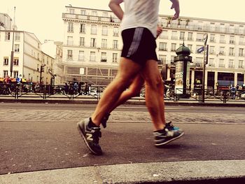 Full length of man running on city street
