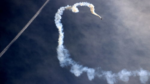 Low angle view of airshow against sky