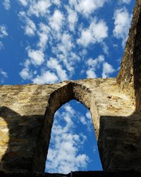 Low angle view of old ruins against blue sky