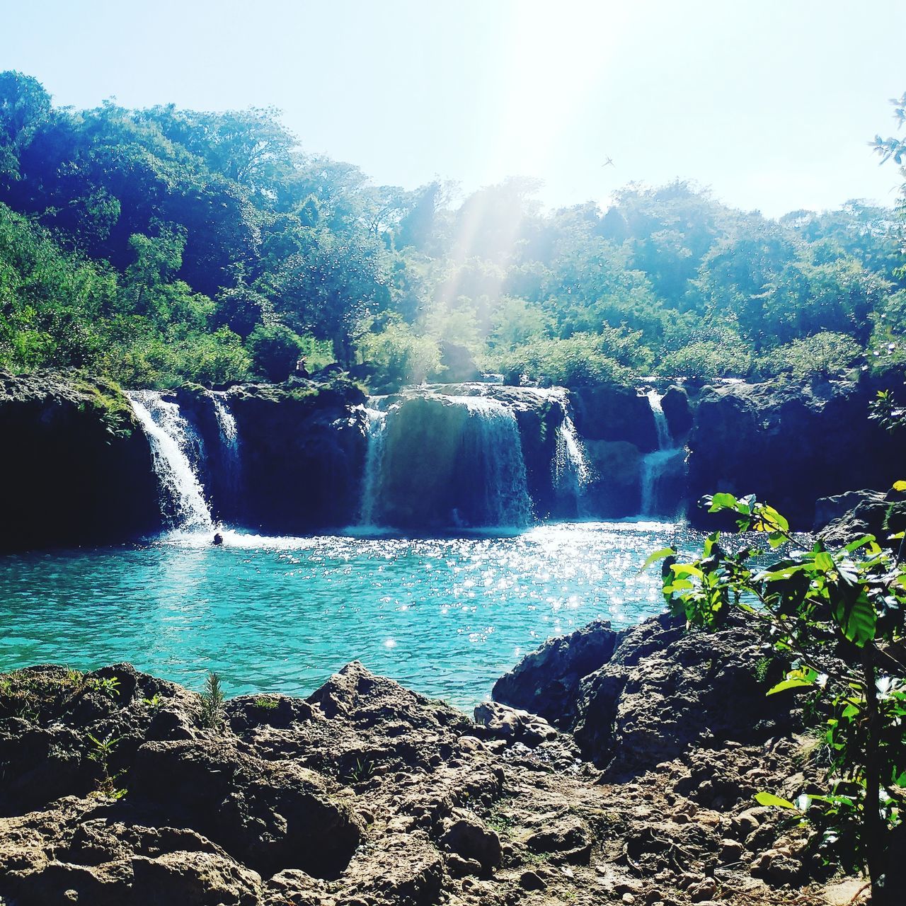 SCENIC VIEW OF WATERFALL AGAINST SKY