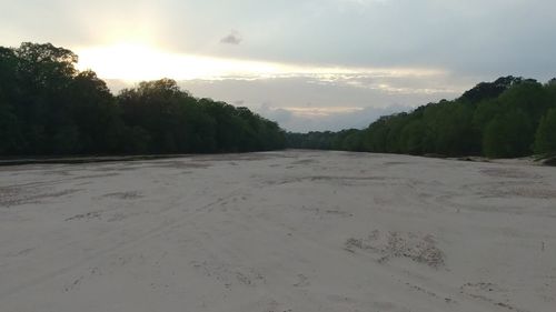 Scenic view of beach against sky during sunset