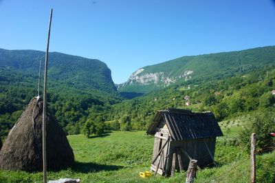 Scenic view of mountains against clear blue sky