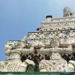 Low angle view of statues against sky