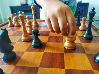 Low angle view of man playing on chess board