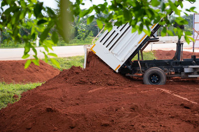 Tilt image of vehicle on field against sky