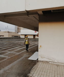 Full length of woman walking on footpath in city