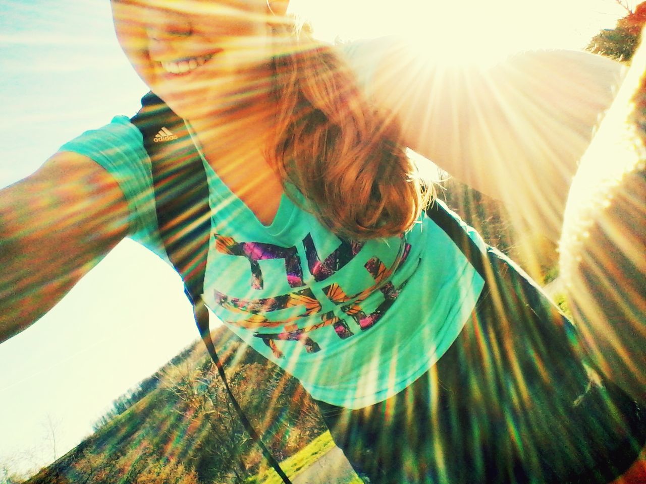 lifestyles, leisure activity, sunlight, sunbeam, sun, casual clothing, lens flare, sunny, person, young adult, standing, day, shadow, outdoors, low angle view, young women, bright