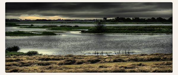 Scenic view of landscape against cloudy sky