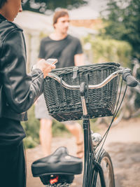 Midsection of man with bicycle on basket