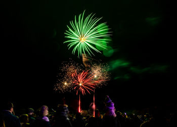 Low angle view of firework display at night