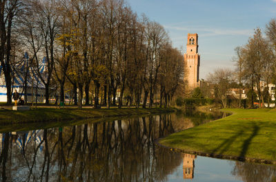 Reflection of trees and buildings on lake