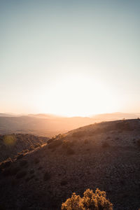 Scenic view of landscape against clear sky during sunset