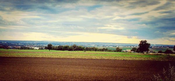 Scenic view of landscape against cloudy sky