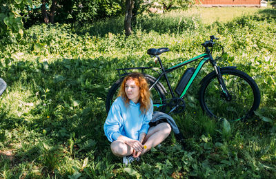 A young woman uses a modern electric bicycle for sports and outdoor recreation