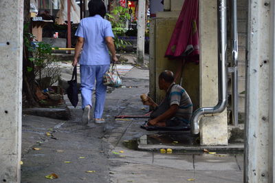 Rear view of people working on street