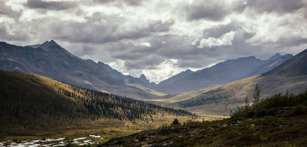 Scenic view of mountains against storm clouds