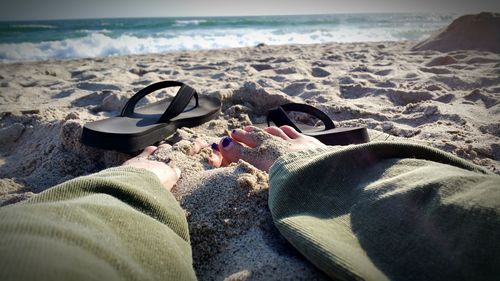 Low section of people relaxing on beach