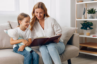 Young woman using laptop while sitting at home