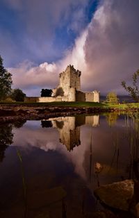 Castle and clouds lake reflections in killarney national park, co. kerry, ireland