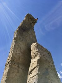 Low angle view of rock formation against blue sky