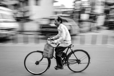 Man riding bicycle on road