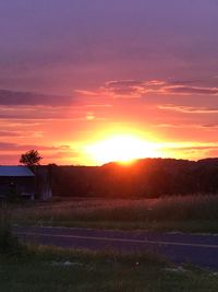 Scenic view of field against sky during sunset