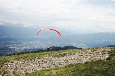 Kite flying over land against sky