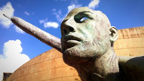 Low angle view of statue against blue sky