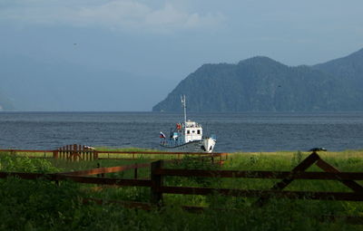 Scenic view of sea and mountains against sky